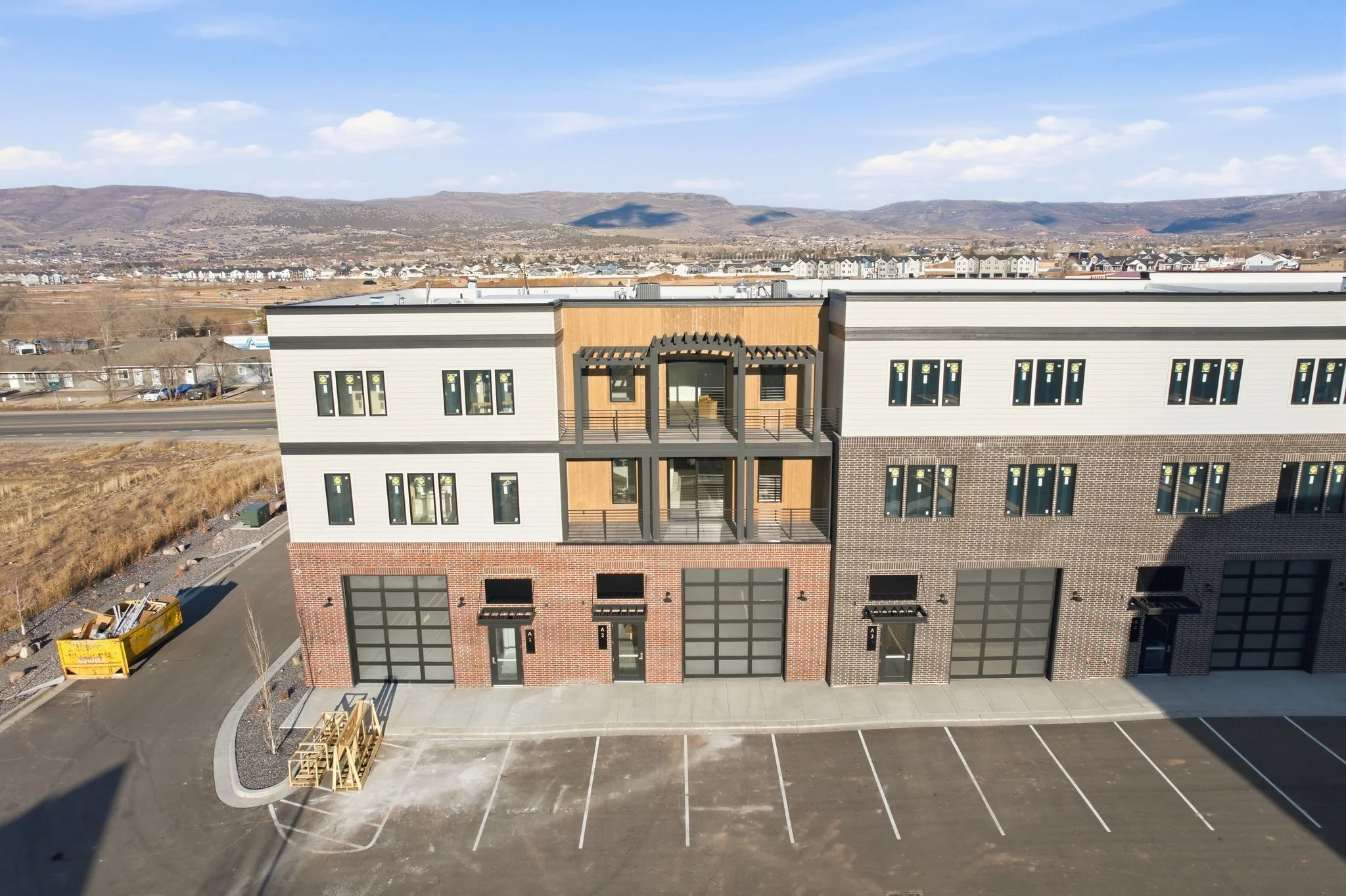 Close aerial approach showing buildings and parking lots at Mountain View Commons