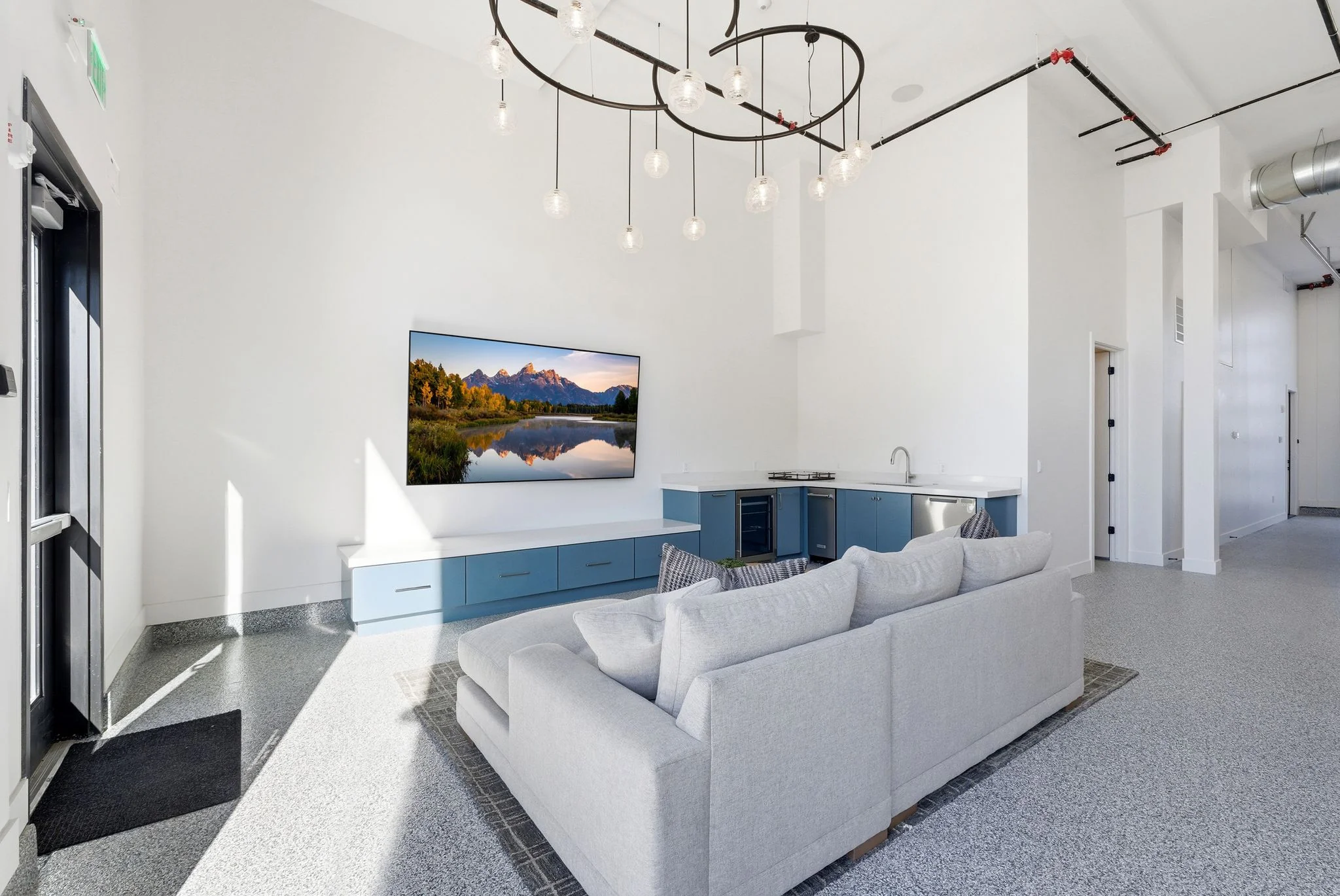Loft lounge with terrazzo flooring and sculptural lighting