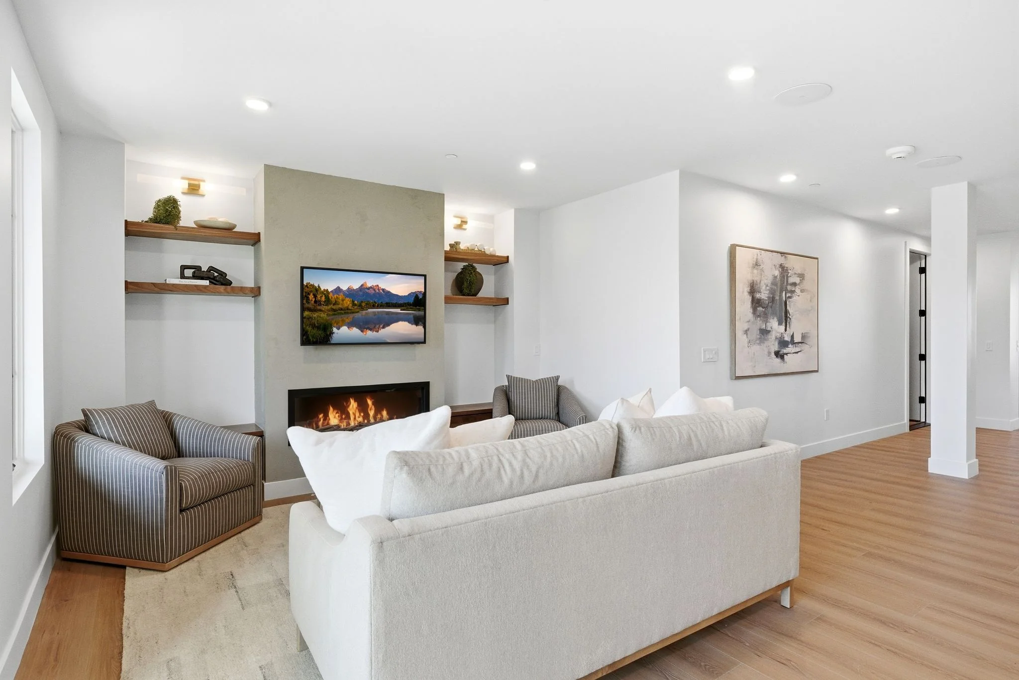 Living room wide view with fireplace at the Outlaw model